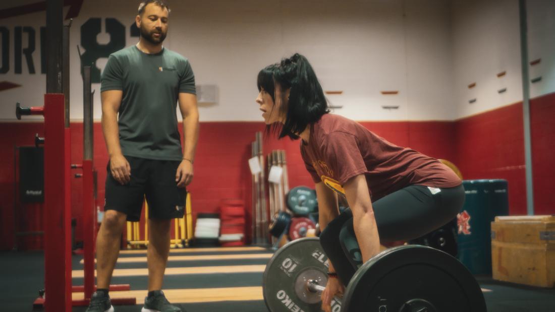 Image of personal trainer and weightlifting